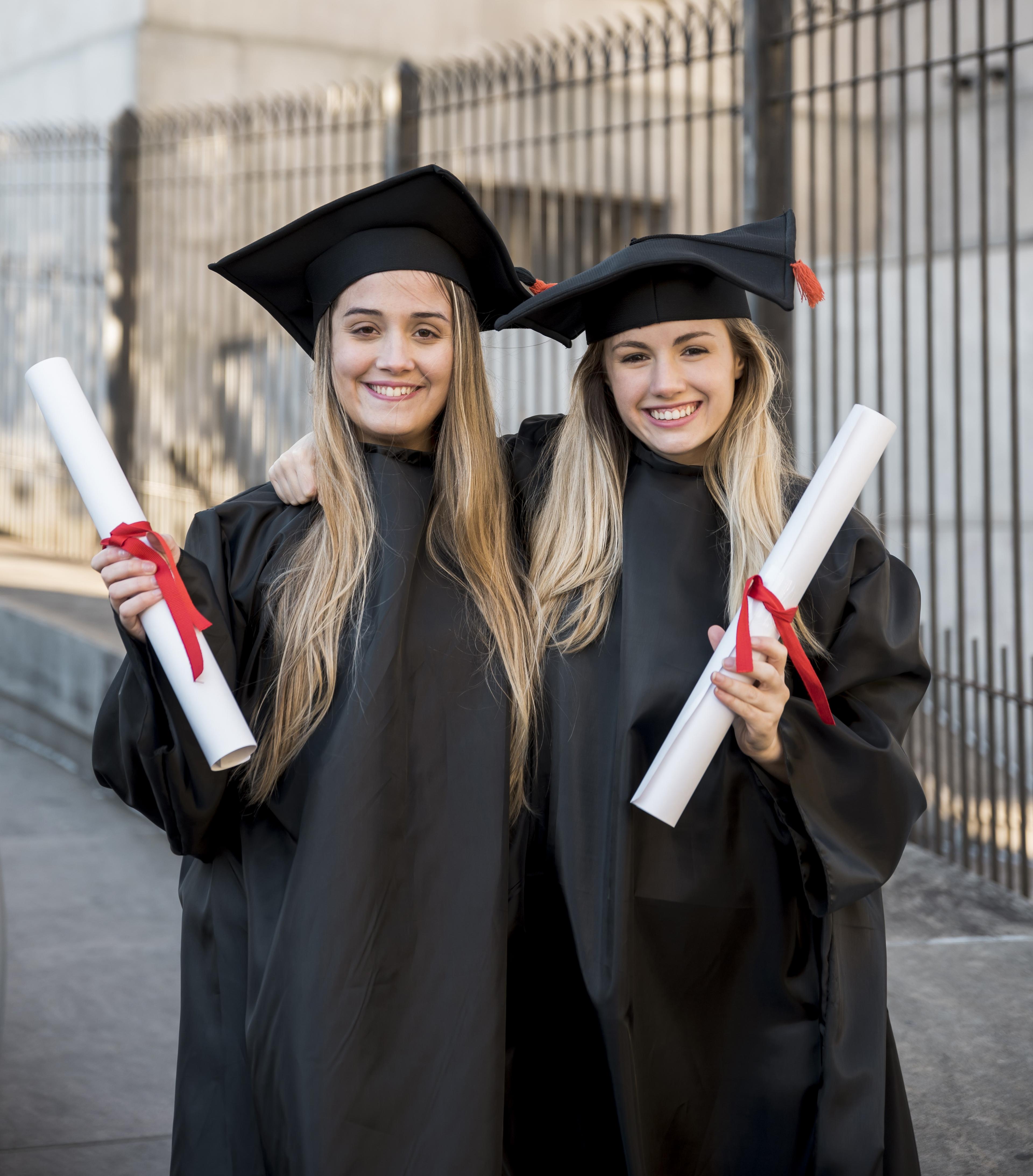 Happy graduates in graduation caps