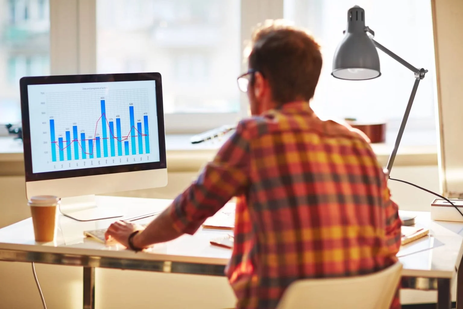 Student taking IELTS mock test on computer with analytics dashboard